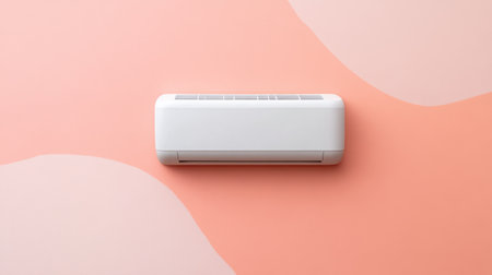 A stylish modern air conditioning unit mounted on a peach wall, featuring abstract shapes, showcasing comfort and cooling technology for contemporary interiors.の素材