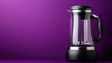 A stylish glass electric kettle stands elegantly against a vibrant purple background, highlighting modern kitchen design and appliance functionality.の素材