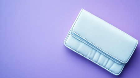 A stylish light blue wallet rests on a soft purple background, perfect for showcasing modern accessories in lifestyle and fashion photography.の素材