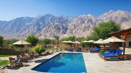 A peaceful resort features a sparkling swimming pool, alluring lounge chairs, and stunning mountain views, perfect for a relaxing vacation in nature.の素材