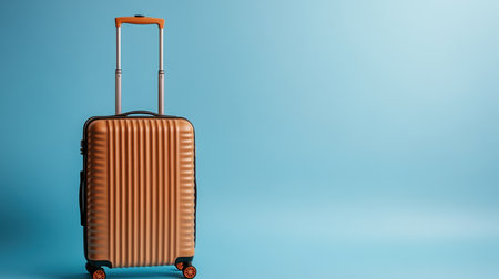 This image features a stylish modern carry-on luggage with a unique hardshell design set against a vibrant blue background, perfect for showcasing travel essentials.の素材