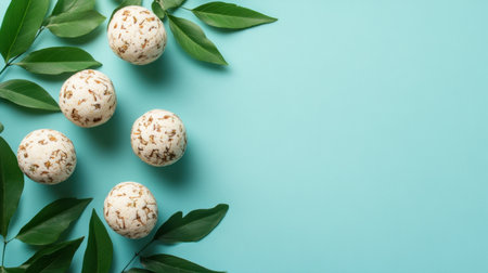 A serene display of natural bath bombs made with organic ingredients, artfully arranged among fresh green leaves on a tranquil blue background, ideal for spa and relaxation themes.の素材