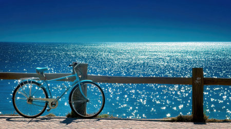 A serene and picturesque scene featuring a blue bicycle resting against a wooden railing by the sparkling ocean. Ideal for travel and outdoor themes.の素材