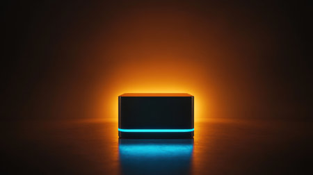 A modern box radiates a captivating glow with vibrant orange and blue lights, creating a striking visual against a dark reflective surface.の素材