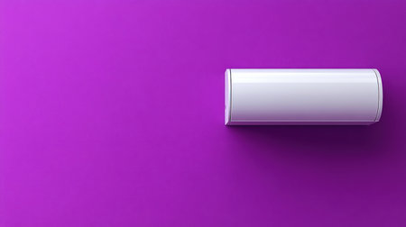 A white round container rests on a vibrant purple background, creating a striking visual contrast ideal for product display or marketing purposes.の素材