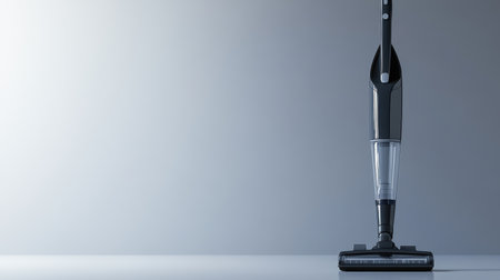 A sleek and modern cordless vacuum cleaner stands elegantly against a soft gradient background, symbolizing innovation in home cleaning with stylish design.の素材