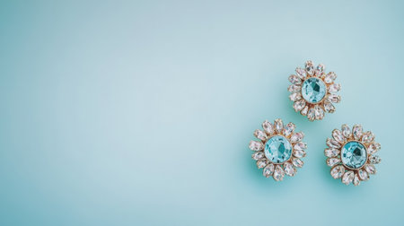 Discover a stunning arrangement of vintage brooches featuring blue gemstones on a serene aqua background. Perfect for fashion enthusiasts and collectors.の素材