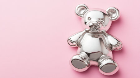 A delightful silver teddy bear figurine rests on a soft pink background, perfect for adding a touch of whimsy and charm to any space, creating a serene atmosphere.の素材