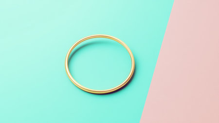 A beautifully simple gold ring sits against a vibrant pastel background, perfect for highlighting jewelry design or fashion concepts in visual projects.の素材