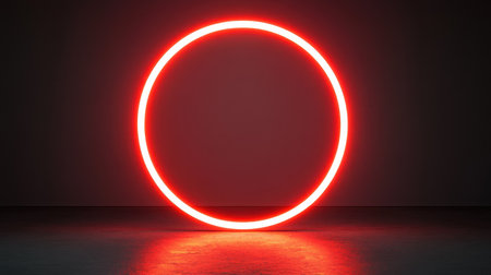 This image features a bright red neon circle set against a dark background, creating a striking visual effect with reflections on the floor. Ideal for modern design.の素材