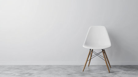 This image features a stylish modern chair positioned against a pristine white wall, embodying a minimalist design aesthetic for contemporary interiors.の素材