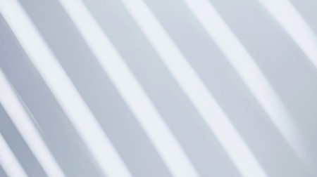 This image features an abstract pattern of soft light and gentle shadows on a smooth surface, creating a minimalist design that evokes tranquility and elegance.の素材