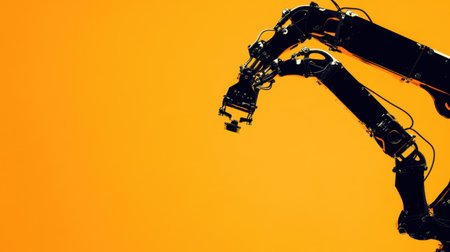 A sleek robotic arm stands out against a bright orange background, showcasing the future of automation and advanced technology in various industries.の素材