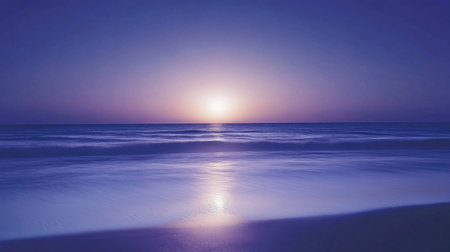 A captivating sunset scene showcases a vibrant sky filled with soft blue and purple tones over the calm ocean, reflecting on the water's surface, conveying serenity.の素材