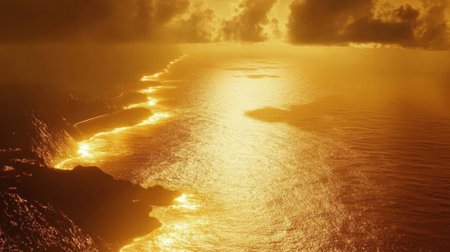 A stunning view of a sunset over the ocean, showcasing golden reflections on the water surface and dramatic cloud formations in the sky.の素材