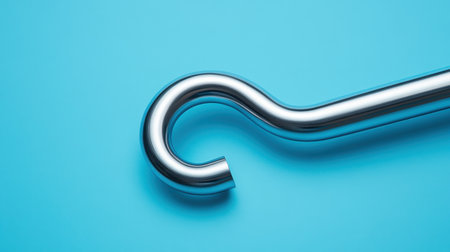 This image showcases a sleek metallic hook on a bright blue backdrop, emphasizing modern design and minimalism. It captures the curves and shine, ideal for product displays.の素材