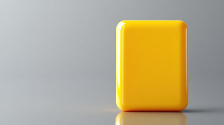 A vibrant yellow square object stands alone on a smooth surface, showcasing minimalism and contemporary design. The reflective quality adds a touch of elegance.の素材
