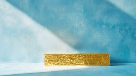 This image features a sleek gold bar set against a soft blue background, illuminated by soft lighting. It embodies modern elegance and simplicity, perfect for creative projects.の素材