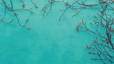 A stunning visual featuring delicate branches with subtle golden leaves against a vibrant turquoise wall. Perfect for nature and interior design themes.の素材