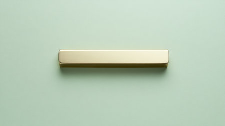 A minimalistic gold bar resting on a soft green background, creating an elegant and modern aesthetic suitable for various design projects and creative ideas.の素材