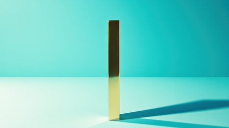 A striking gold block stands upright on a turquoise surface, casting a dramatic shadow. The minimalist design highlights the interplay of light and color for a contemporary artistic feel.の素材