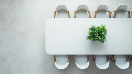 A beautifully designed modern office space featuring a sleek white table surrounded by stylish chairs, complemented by a touch of greenery.の素材