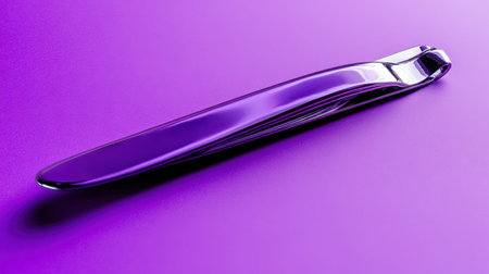 A sleek silver spoon gracefully rests on a vivid purple background, showcasing a modern and stylish culinary accessory perfect for contemporary dining aesthetics.の素材