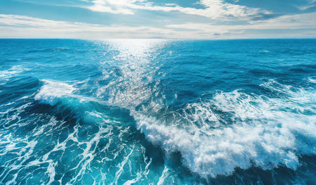 Aerial view of sea waves and splashes on blue sky backgroundの素材