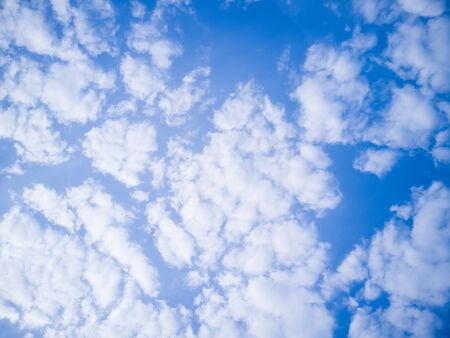 Blue sky background with clouds on a blue backgroundの写真素材