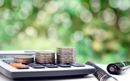 Stack coins or money on a financial concept calculator Saving money for investmentの写真素材