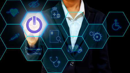 The woman's hand that presses the switch includes a medical icon, a concept of health care and...