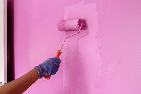 Close-up of the painting, in the hands of the painter, the concept of labor and painting.の写真素材