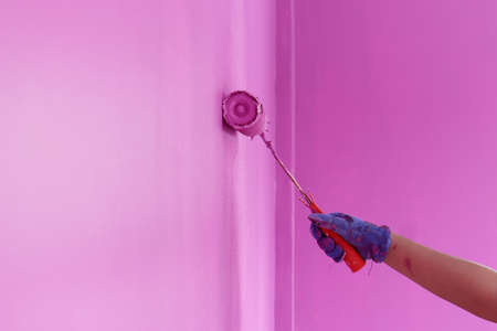Close-up of the painting, in the hands of the painter, the concept of labor and painting.