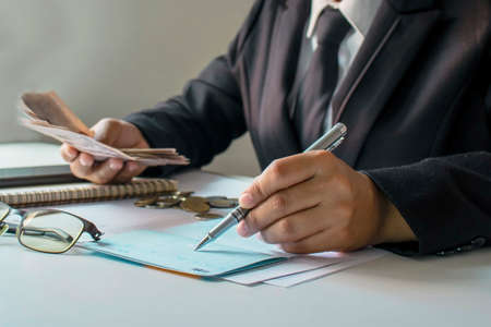 The businessman is examining accounting and business income ideas on financial and work management....