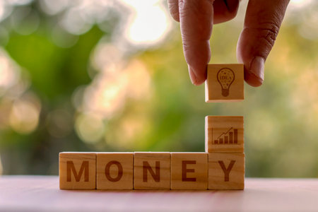 Square wooden blocks with money notes and shopping planning ideas and shopping ingenuity.の写真素材