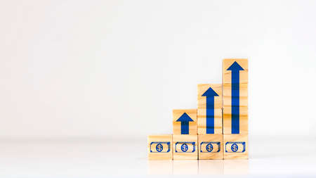 Growing growing blocks of wood and arrows, financial growth ideas, business improvement and comparison ideas.の写真素材