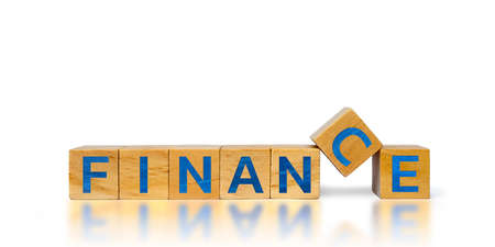Stacked wooden cubes with finance text on separate wooden cubes on white backgroundの写真素材