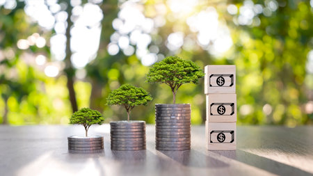 Coin and plant on coin pile ideas for saving money and investing in the business.の写真素材