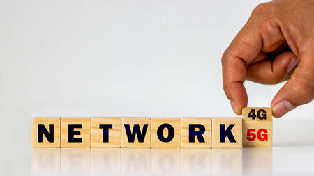 Hands are turning the cube of 4G numbers to 5G, the concept of 5G network and the connection of...