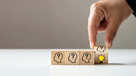 Businessman choosing light bulb icon, full of ideas and creativity on the wooden cube, financial...