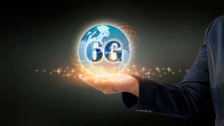 Close-up shot of mobile holding 6G hologram. Futuristic technology concept and internet speed.の写真素材