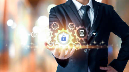 businessman holding financial security protection icon The concept of protection from Internet threats.の写真素材