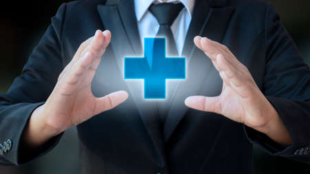 business man holding positive virtual medical network connection icon health care concept doctor document medicine ambulance patient iconの写真素材