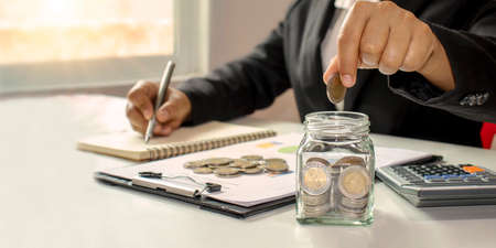 Working men aged 25-60, put coins in a glass jar to save money. Retirement Financial Planning Ideas...