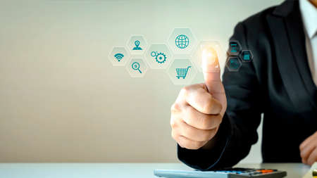 Businessman scanning fingerprints and biometric authentication, financial transaction security concept.の写真素材