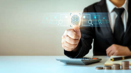 Businessman with fingerprint scanning and biometric authentication cybersecurity concept fingerprint password and financial transactions through technology in the futureの写真素材
