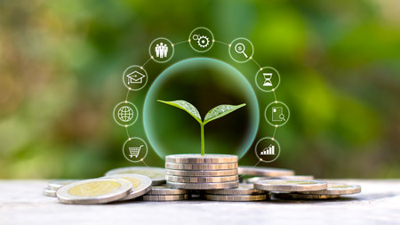 Tree growing on a pile of coins and finance, investment icons with the concept of financial system development and economic growth.の写真素材