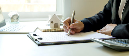 Business man signing documents Writing a signature on a contract or sales agreement.の写真素材