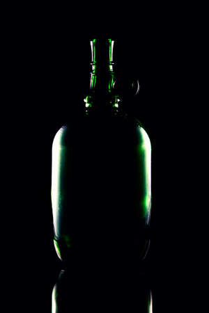 Still life of colorful bottles of wine on a black background.の写真素材