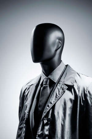 Fashion mannequin in elegant black suit over dark grey background. Black White photoの写真素材